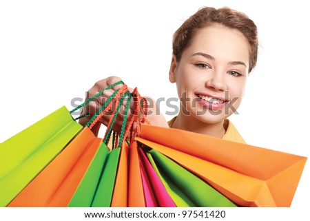 Young girl holding shopping bag, isolated on white background