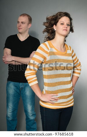 Happy young couple isolated on grey background