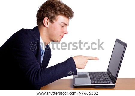 Young man pointing with finger on laptop Royalty-Free Stock Photo #97686332