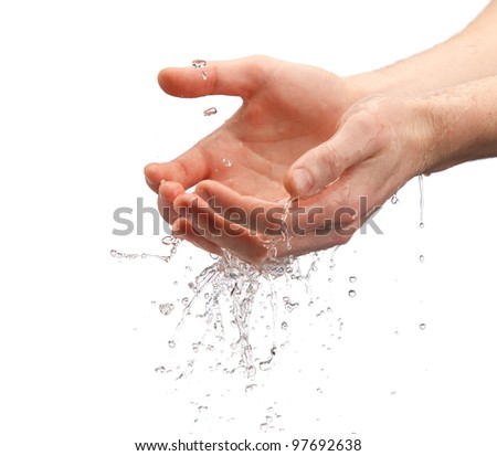human hands with water splashing on them