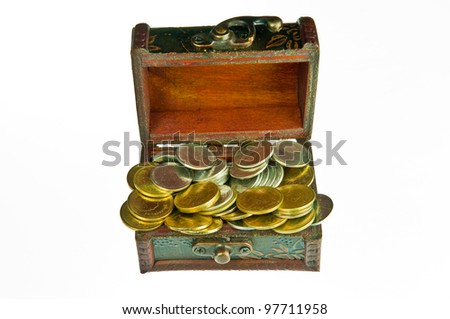Old style wooden box full with gold money isolated on white background.
