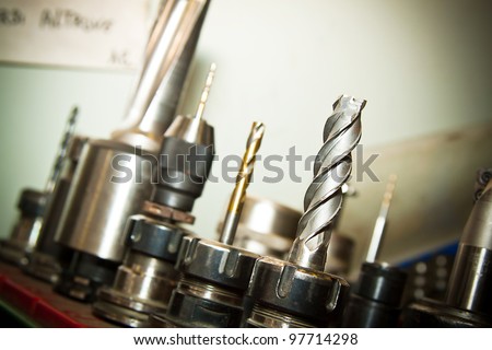 Detail of drilling machine bits in a high precision mechanics plant. Royalty-Free Stock Photo #97714298