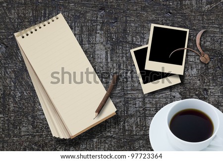 notebook and photo frame on background