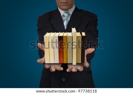 Stack of Book in Hand of Business Man
