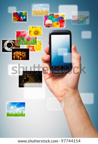 Hand holding phone with multimedia