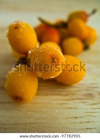 frozen sea buckthorn on wooden background Royalty-Free Stock Photo #97782905
