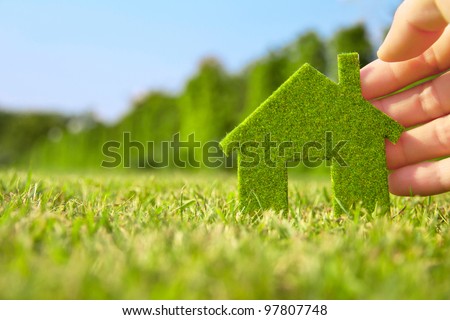 Eco house concept ,hand holding eco house icon in nature Royalty-Free Stock Photo #97807748