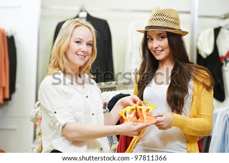 Two Young women with summer clothing during garments shopping at apparel store
