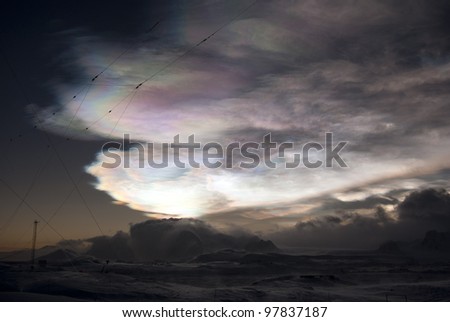 Nacreous clouds over the mountains of the Antarctic Peninsula winter's night. Royalty-Free Stock Photo #97837187