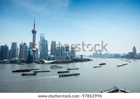 shanghai pudong skyline and busy huangpu river