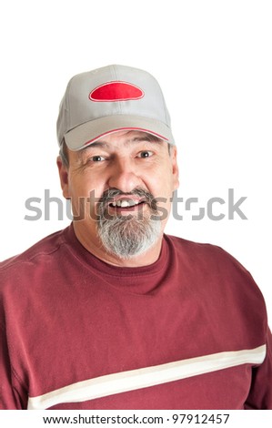 Good natured smile from a sixty five year old man wearing a baseball cap. isolated on a white background.