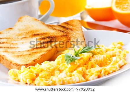 breakfast with scrambled eggs, toasts, juice and coffee Royalty-Free Stock Photo #97920932