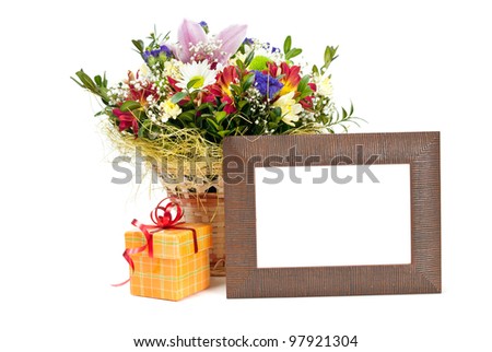Gift box and wooden picture frame with flowers on white background