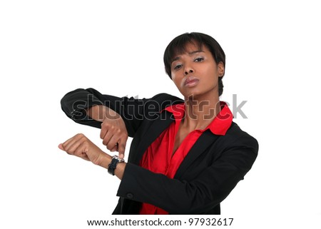 Businesswoman pointing at her watch