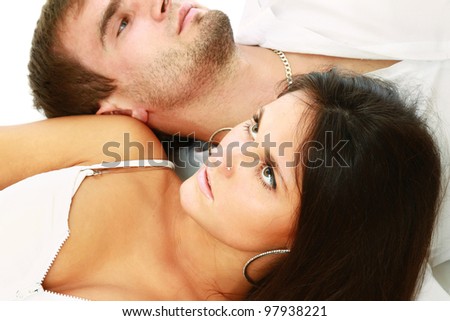 Close-up of young loving couple isolated on white, from above