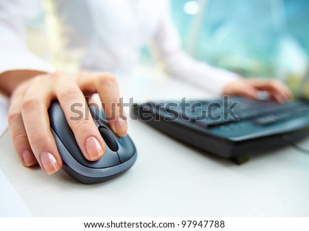 Image of female hands clicking computer mouse Royalty-Free Stock Photo #97947788