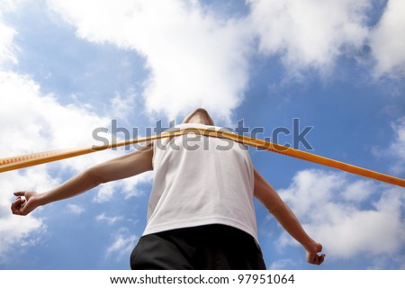 Winning runner with cloud background Royalty-Free Stock Photo #97951064