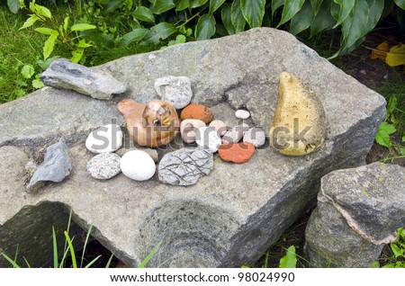 Ancient vintage retro rock stone in garden and decorative objects figure of bird.