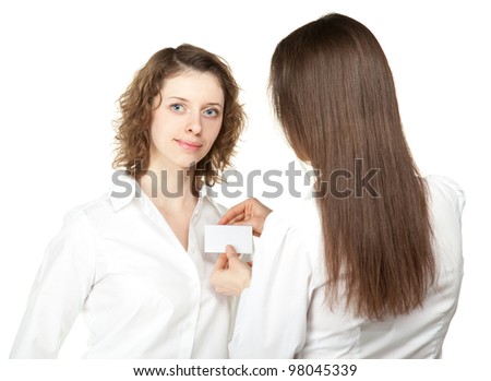 Young woman fastening blank badge to the shirt of participant of a conference/business meeting; young women at business meeting or conference isolated on white