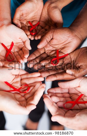 group of multiracial people holding red ribbon for AIDS HIV awareness Royalty-Free Stock Photo #98186870