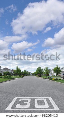 Suburban Neighborhood Thirty Mile Per Hour (MPH) Speed Limit on blacktop paved street in residential district