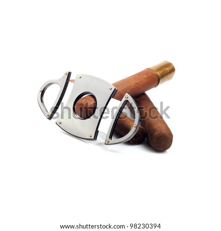 Cigars and a cutter that cut one of it isolated on white background