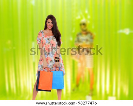Woman in front of a shop Window with shopping bags