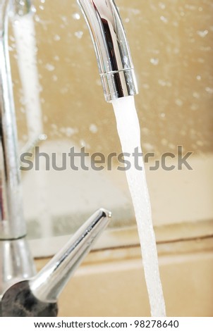 Faucet and water drop isolated on white background