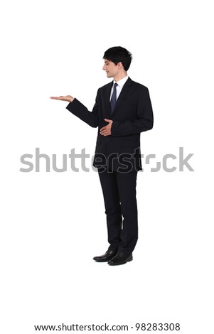Man wearing a suit and presenting his right hand