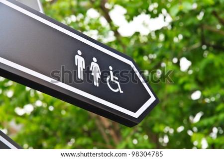 Men and women toilet sign with an arrow showing direction