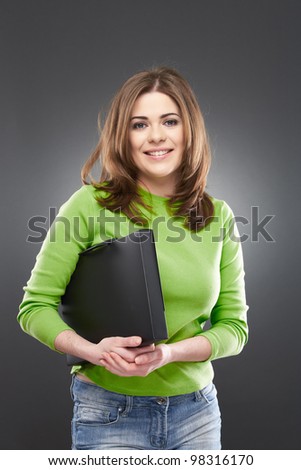 Woman student standing over gray background. Toothy smile