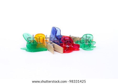 Clip Art with wooden clothes pins and colorful semi-opaque plastic clips on isolated white background