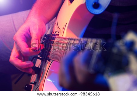 rockstar playing solo on guitar Royalty-Free Stock Photo #98345618