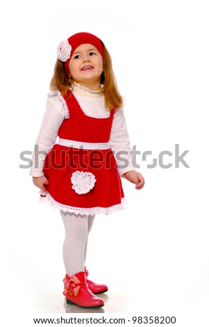 a little girl in a knitted dress on a white background