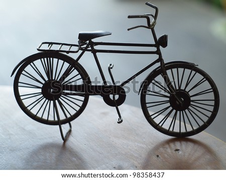Vintage model bicycle on old wooden table.