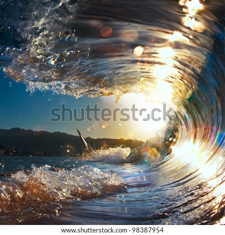 sunset sea curly breaking wave shining in sunlight