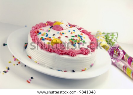 Birthday cake and party blowers on a white background.