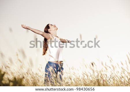 Outdoor portrait of a woman on a meadow releaxing Royalty-Free Stock Photo #98430656