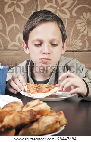Young Boy Eating Pizza
