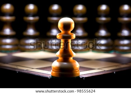 It is a lot of chessmen on a chess board. (are located it is horizontal). A black background. Royalty-Free Stock Photo #98555624