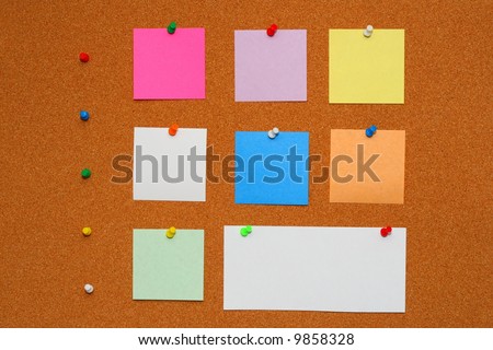 Bulletin board with pinned papers.Color pins with color note paper.