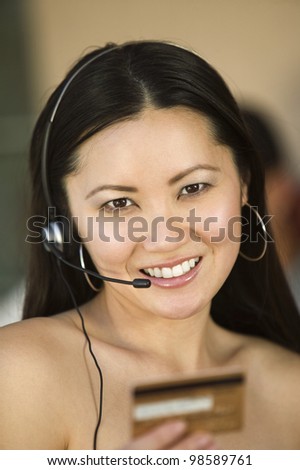 Woman with Headset and Credit Card