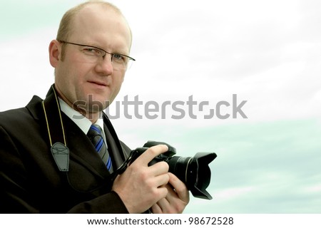 businessman outdoors with camera