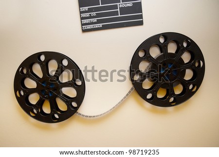 Two retro motion picture film reels with clapper board on the wall