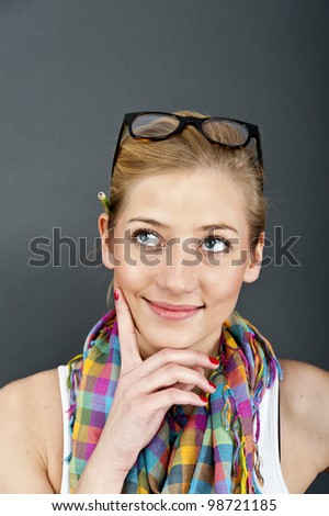 young woman look up on blue background