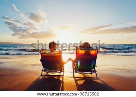 Happy Romantic Couple Enjoying Beautiful Sunset at the Beach Royalty-Free Stock Photo #98725502