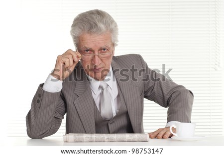 An elderly man in glasses sitting on a isolate