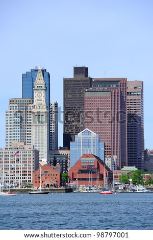 Boston waterfront view with urban city skyline and modern architecture over sea.