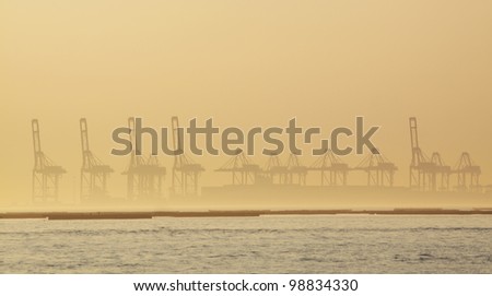 container cranes on a foggy morning