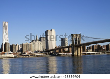 New York City Manhattan skyline with Brooklyn Bridge and skyscrapers over Hudson River in the morning